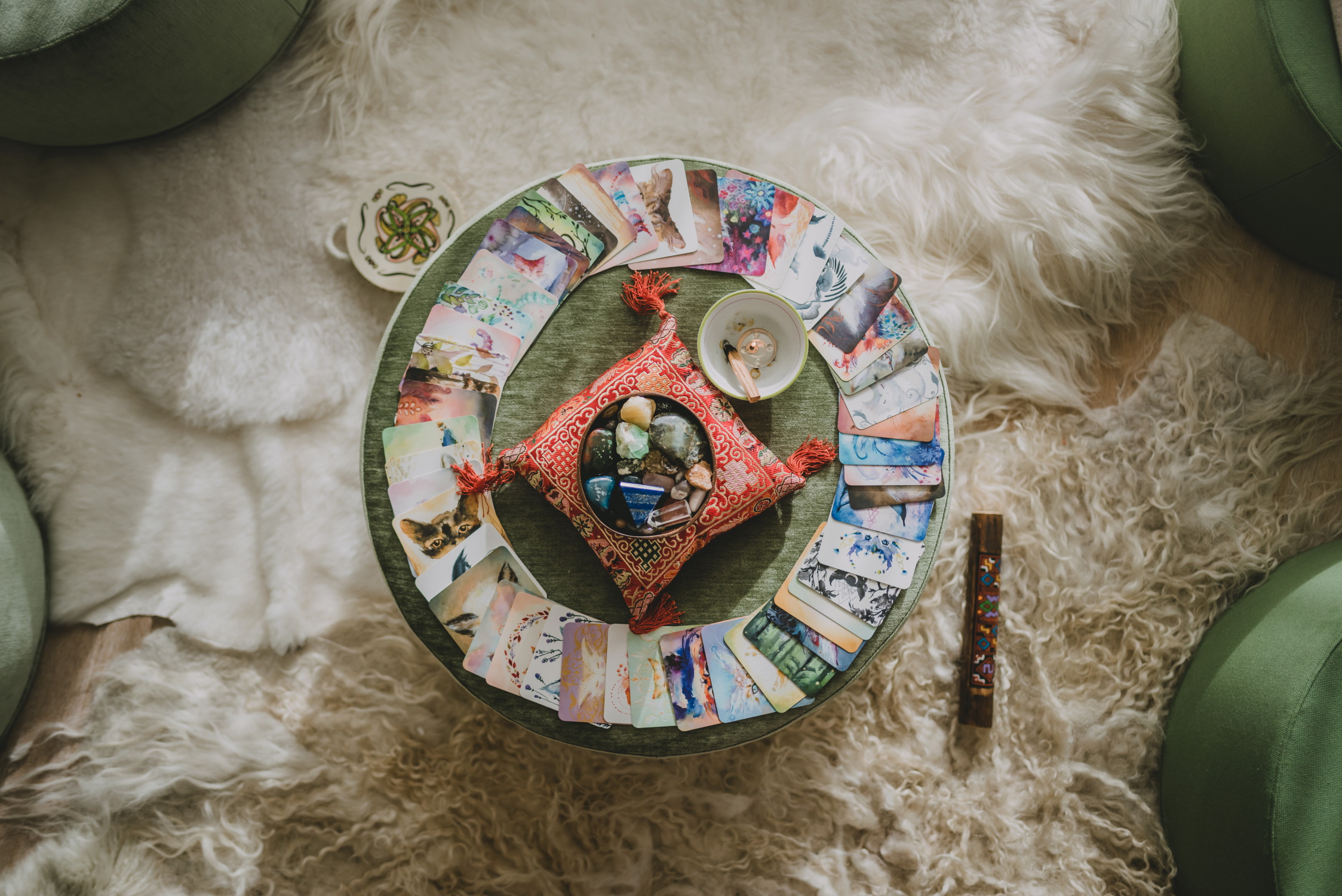 Laptop met website-ontwerp op een houten tafel, naast een notitieboek, agenda en kristallen — Moonrebel werkplek